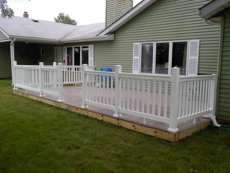 Finished backyard deck with white railing